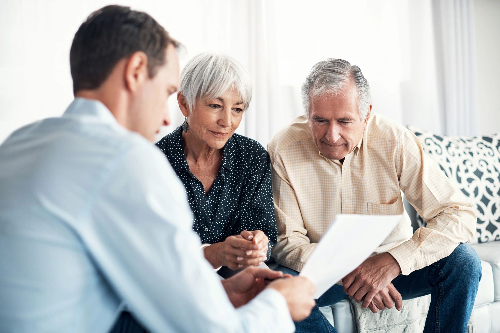 Senior couple receiving property guidance